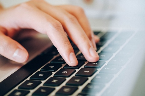 Hand typing on keyboard