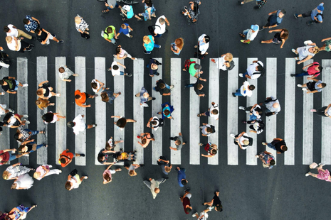 An image of people walking on a crossing.