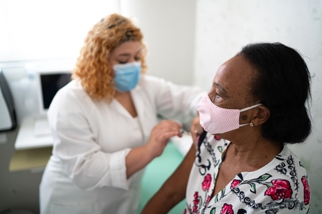 Woman administering vaccine