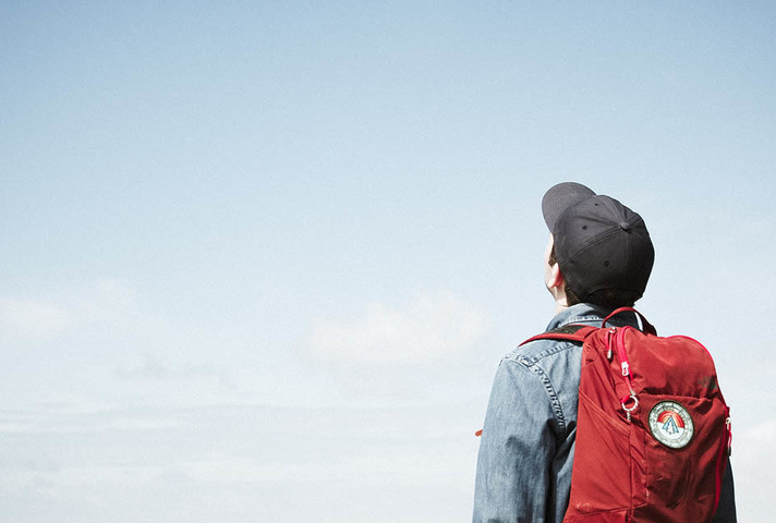 Student looking up at a blue sky