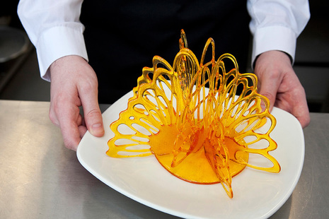 Student chef presenting an intricate sugar shape