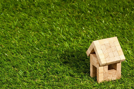 A wooden house on green grass