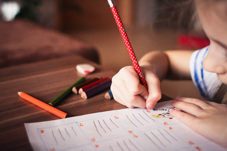 A child colouring on paper