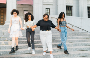 Image of young women holding hands