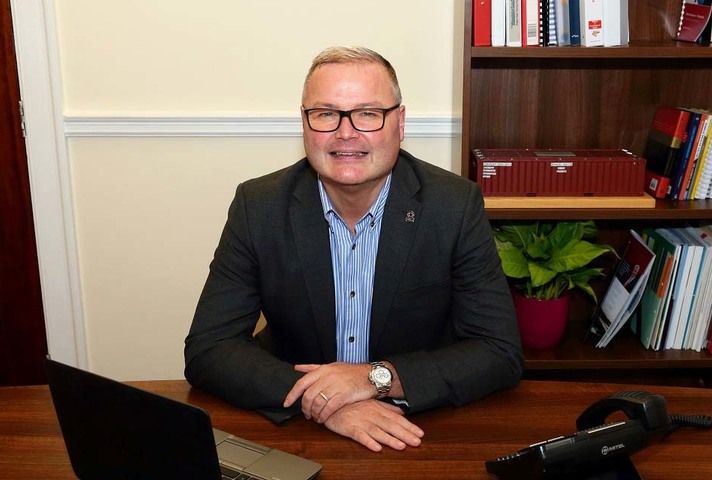 Man sitting behind desk