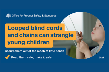 Young child holding a blind cord