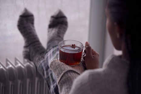 Person with feet up on radiator