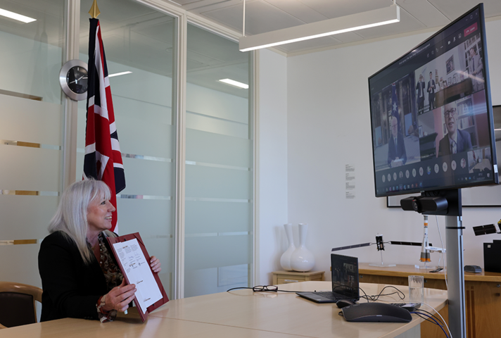 Minister Solloway signing space bridge document