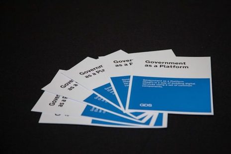 Five blue and white Government as a Platform (GaaP) leaflets fanned out on a black background.