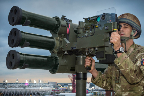 Soldier operating the Lightweight Multiple Launcher (LML) tripod system.