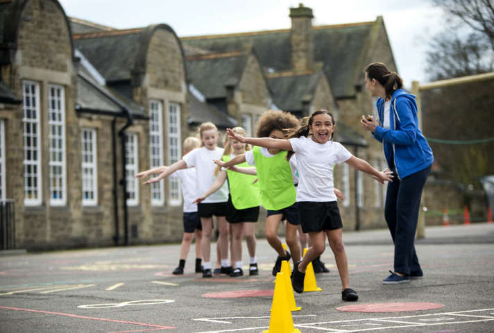 Children having PE lesson in school playground
