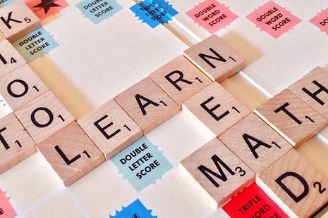 scrabble board with words read and maths and learn on it