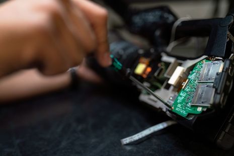 Close up image of screwdriver on computer chip.