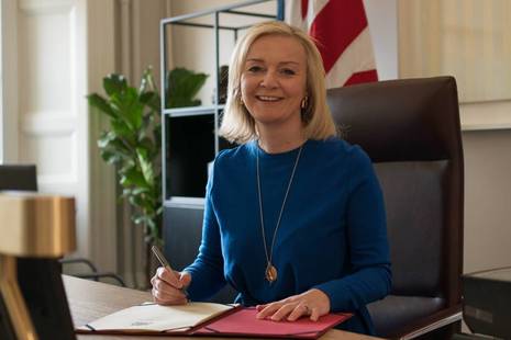 Liz Truss signing Trade Act