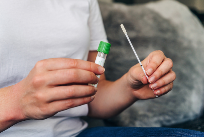 hands holding COVID-19 swab test