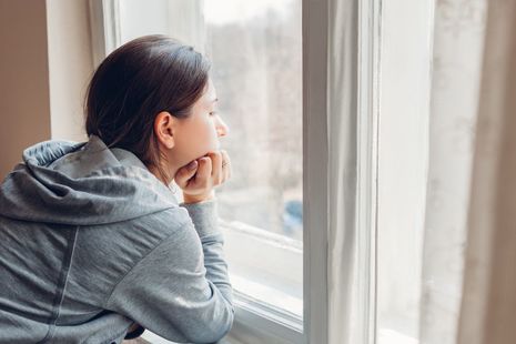 young girl looking out the window