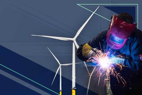 Wind turbines and a man welding