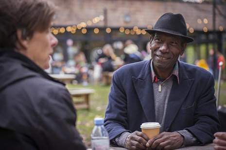 Two men chatting and drinking coffee