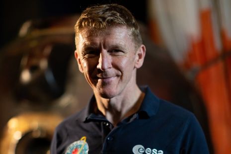 Tim Peake in front of his Soyuz capsule on display at the Science Museum