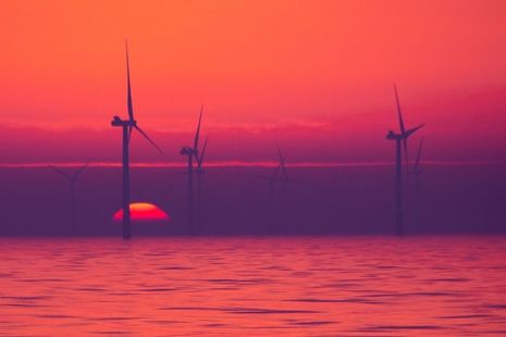 An offshore wind farm at sunset