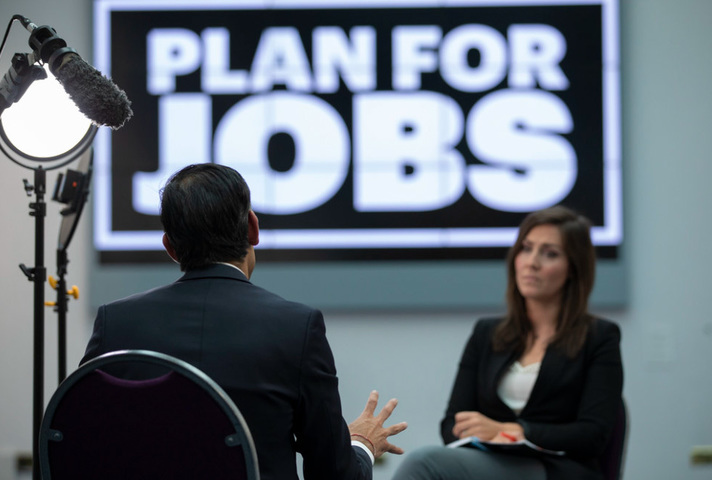 The CX being interviewed by a reporter on Plan for Jobs.