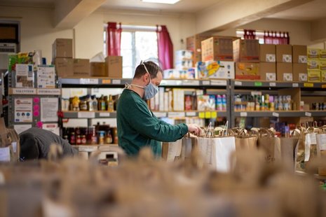 Man in mask organising food bank in UK