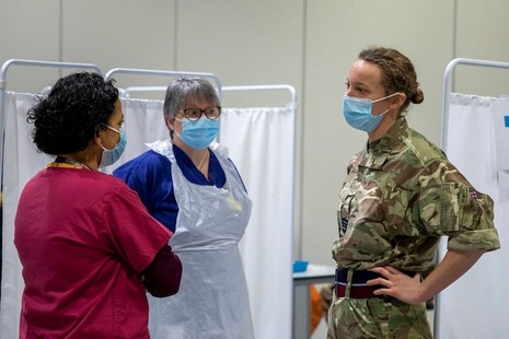 Nurses and member of the military talking