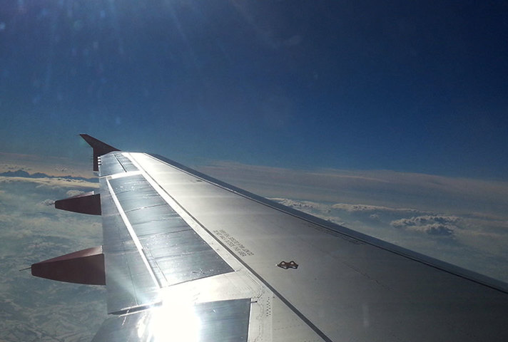 Passenger airplane wing in flight.