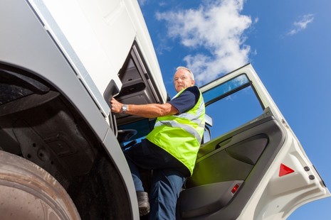 Photo of an HGV driver entering the cab of their vehicle