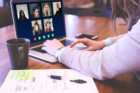 Woman working on laptop in video conference