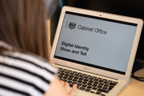 Person viewing a ‘digital identity show and tell’ slide deck on a laptop.