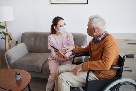 Care worker and man in wheelchair