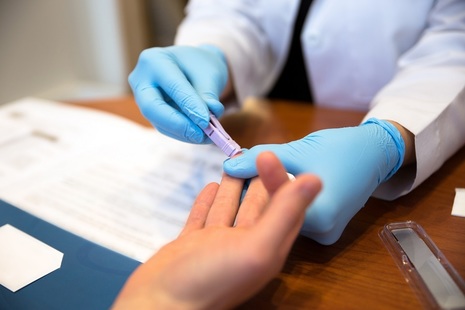 Person taking HIV fingerprick test