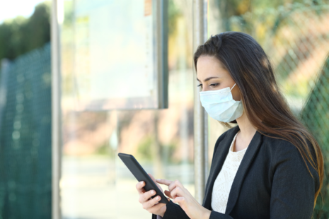 Masked woman using phone