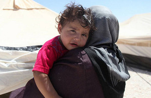 A Syrian refugee woman holds her child in Jordan's Za'atari camp. Photo: UNHCR/Sarah Malkawi