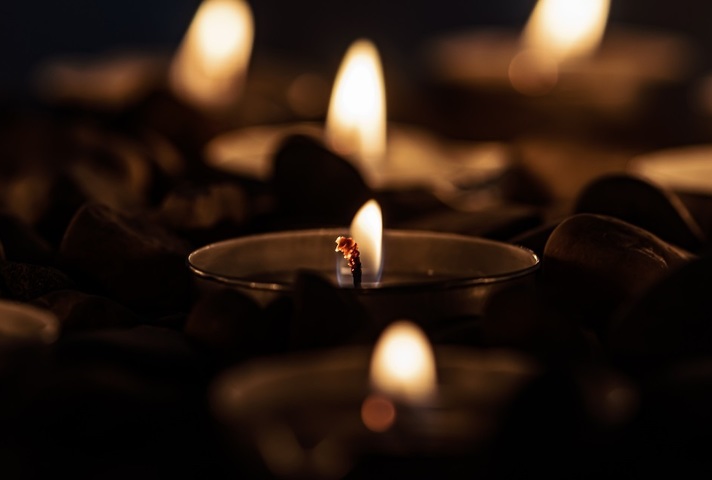 Tea light candles burning at night-time