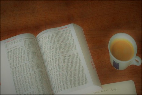 Legal textbook on desk with cup of coffee alongside