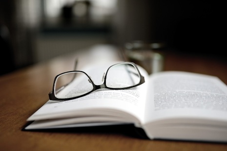 Image of reading glasses on top of book