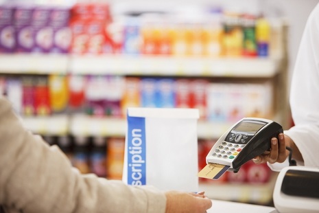 Person paying for a prescription in a pharmacy
