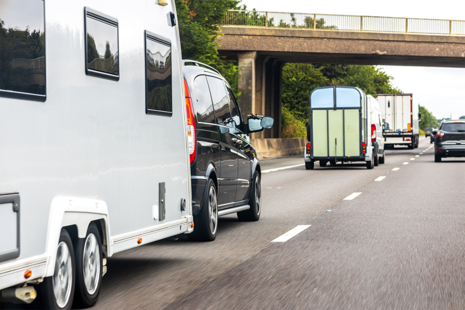 Car towing caravan on motorway