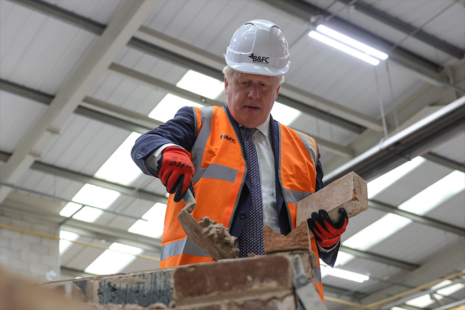 Prime Minister Boris Johnson laying bricks