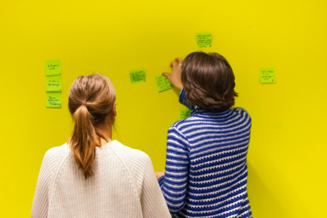 Digital staff putting post-it notes on a wall