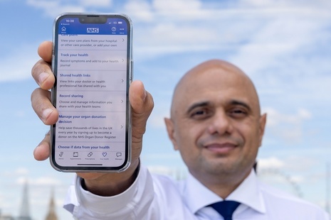 Sajid Javid with NHS App on a phone