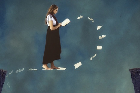 Woman walking in air reading book with papers floating under her feet.