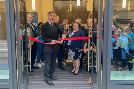 Jacob Rees-Mogg cutting the ribbon at the opening of a new government hub in Birmingham.