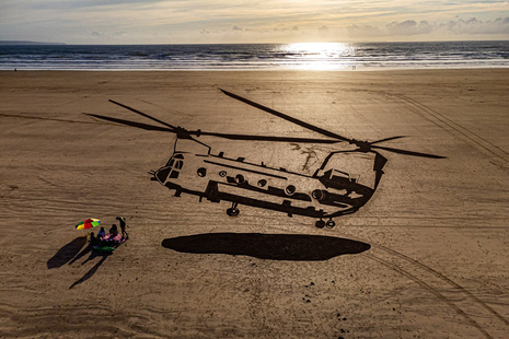 A huge drawing of a military Chinook helicopter appears in the sand on Saunton Sands beach in Devon