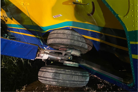 Collapsed main landing gear blocking left cabin door