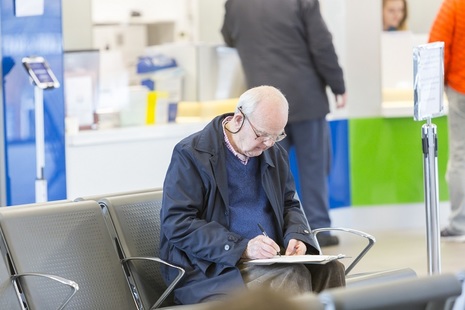elderly gentleman filling out form