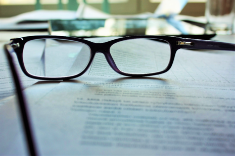 Spectacles on top of contract paperwork