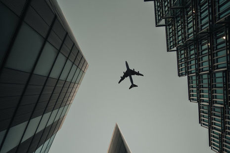 Plane flying over buildings